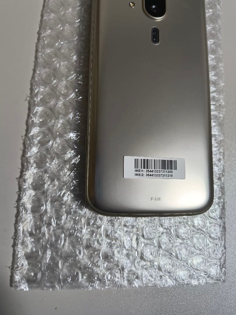 らくらくスマートフォン F-53E ゴールド 新品ケース、フィルム付き
