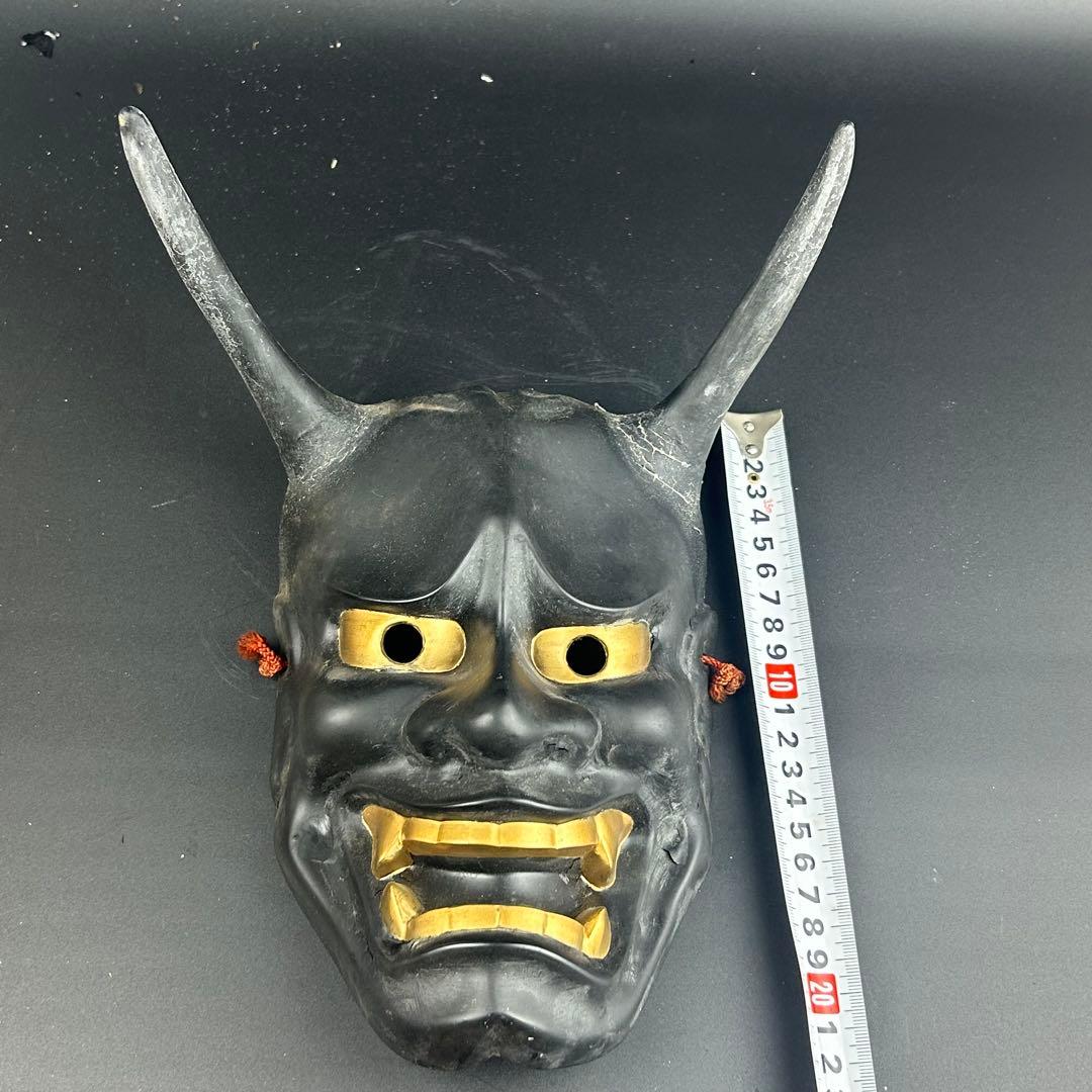 お面　黒と金の角のあるデザイン